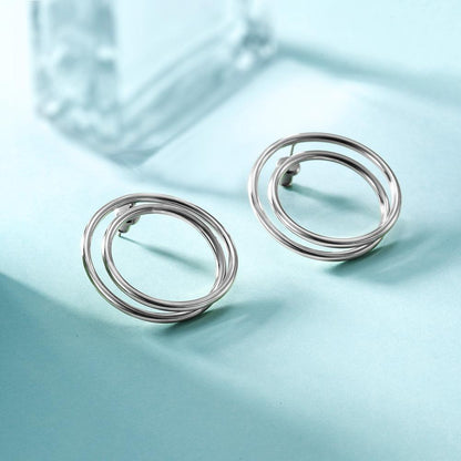 Lavender Phoebe double layered hoop earrings in shiny silver, showcasing their stylish, layered circular design.