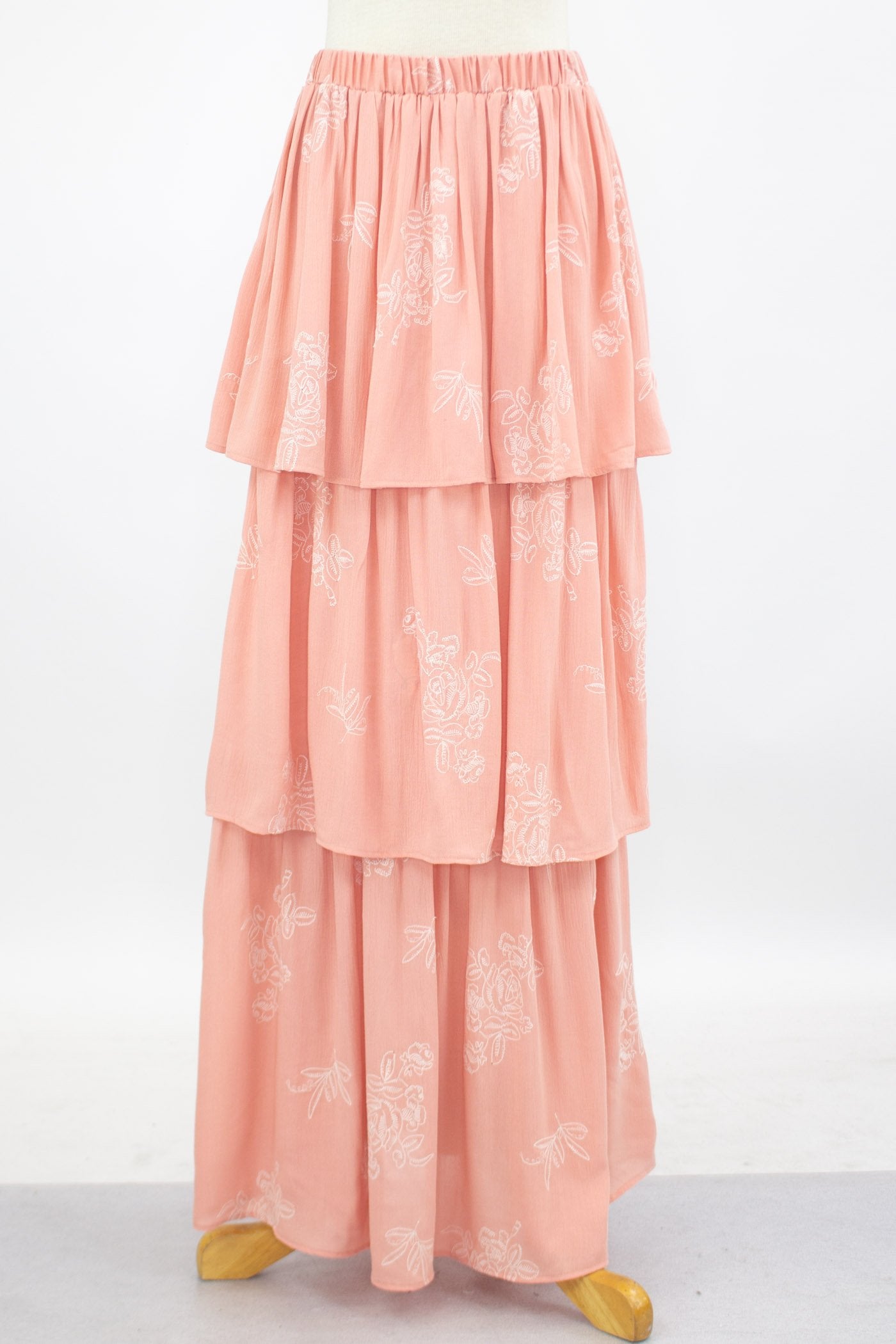 Blush layered ruffle maxi skirt from Yellow Hera, flowing fabric with tiered ruffles for a stylish, feminine look.