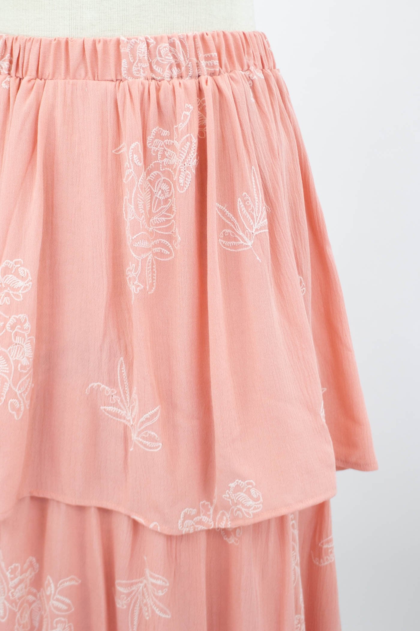 Blush layered ruffle maxi skirt from Yellow Hera, featuring flowing fabric and tiered ruffle details for a stylish look.