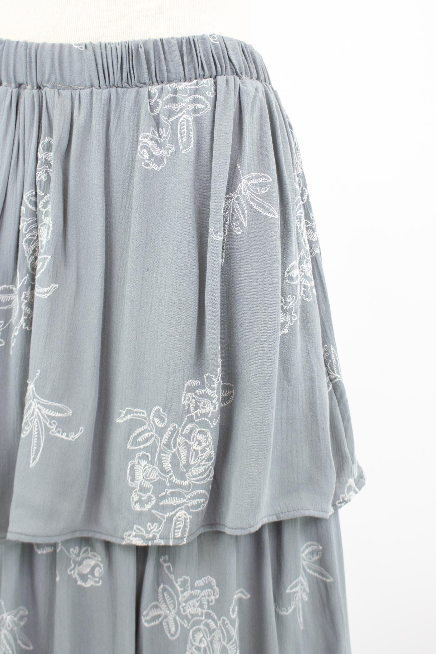 Grey layered ruffle maxi skirt by Yellow Hera, featuring flowing fabric and tiered design, styled for a bohemian look.