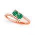 Rose Chloe 14K rose gold two-stone emerald ring, showcasing sparkling gemstones and elegant design.