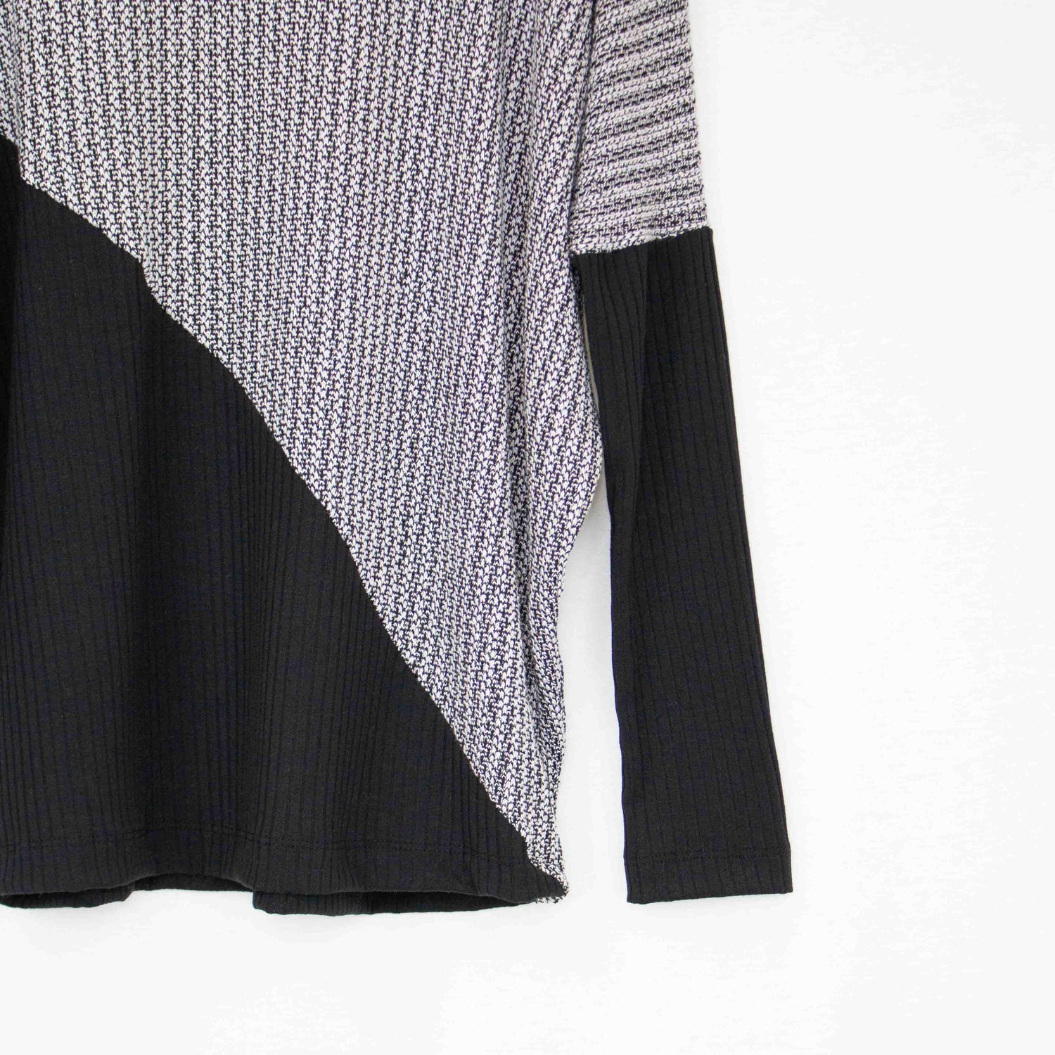Yellow Hera turtle neck sweater featuring a diagonal color block design with long sleeves and a cozy fit.