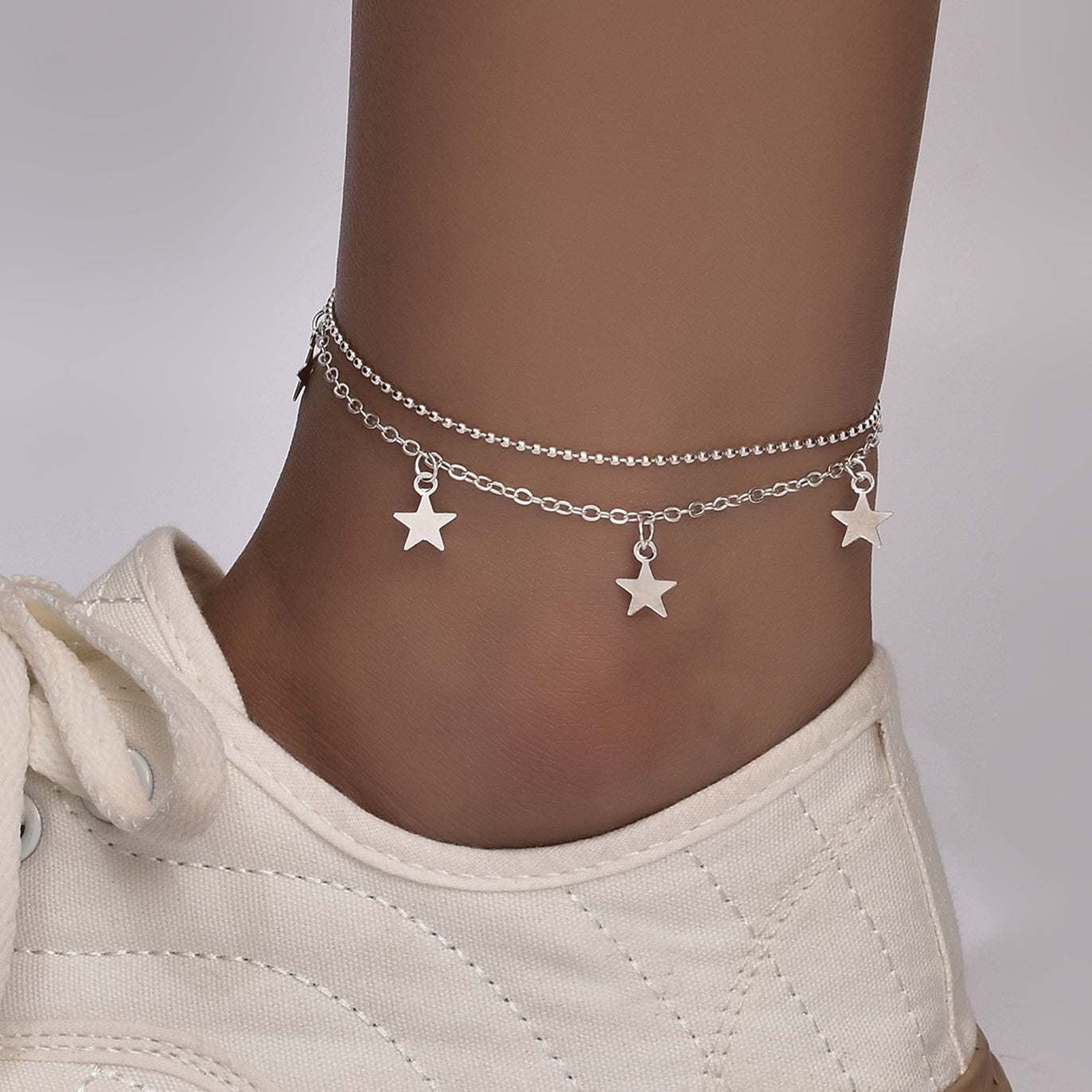 Silver plated butterfly Bohemia chain ankle bracelet with intricate design, from Red Iphigenia, styled as a bohemian accessory.