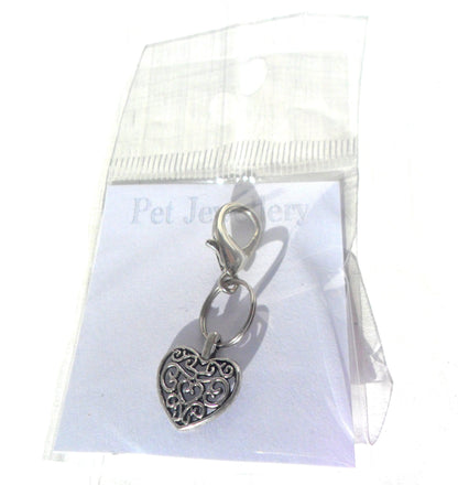 Salmon Oscar filigree heart pet charm attached to a leash or collar, decorative silver accessory for pet wear.