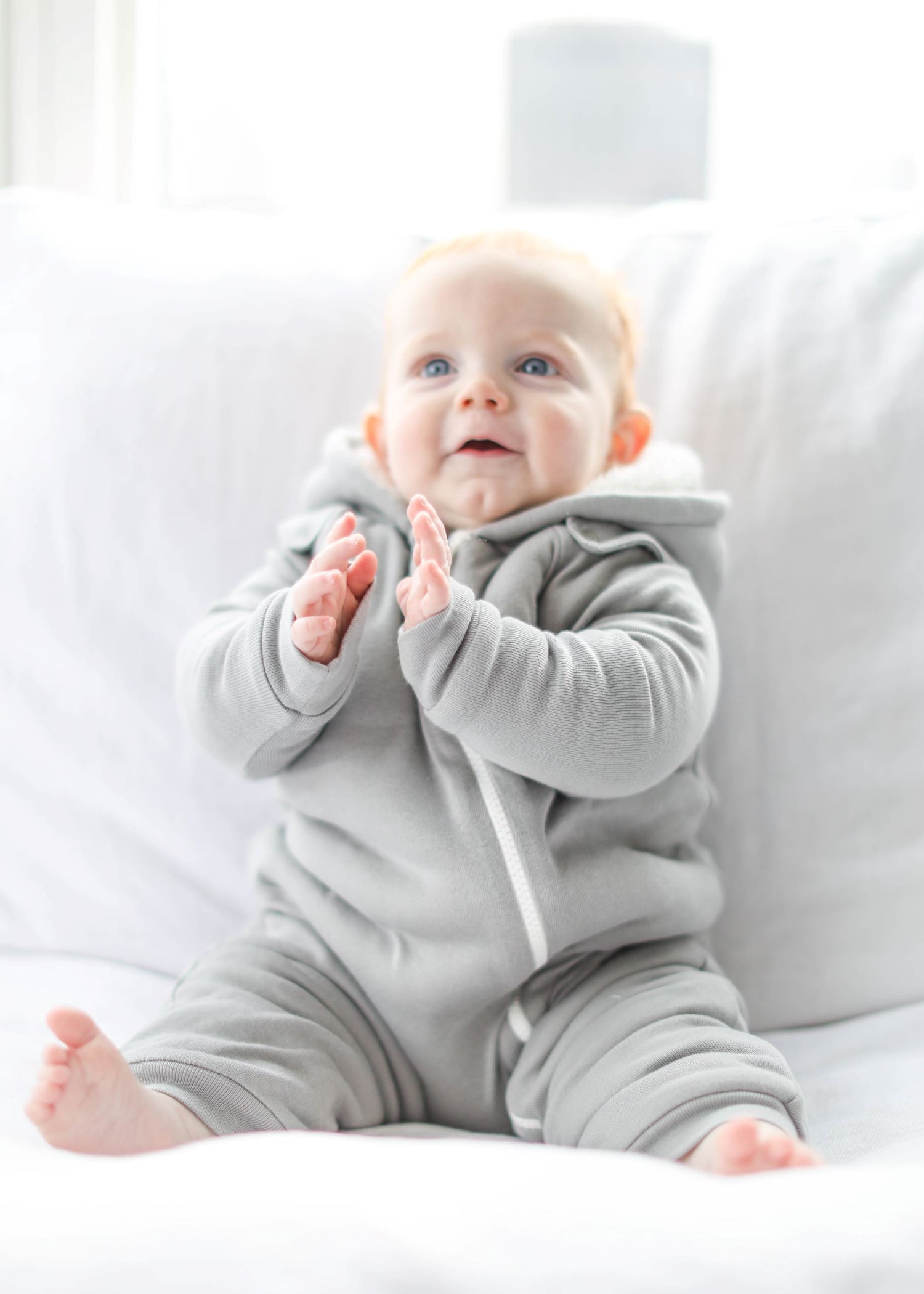 Gray baby jumpsuit and bib by Fuchsia Milo, featuring a cozy, smart cuddly design for comfortable baby clothing.