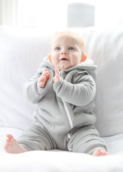 Gray baby jumpsuit and bib by Fuchsia Milo, featuring a cozy, smart cuddly design for comfortable baby clothing.