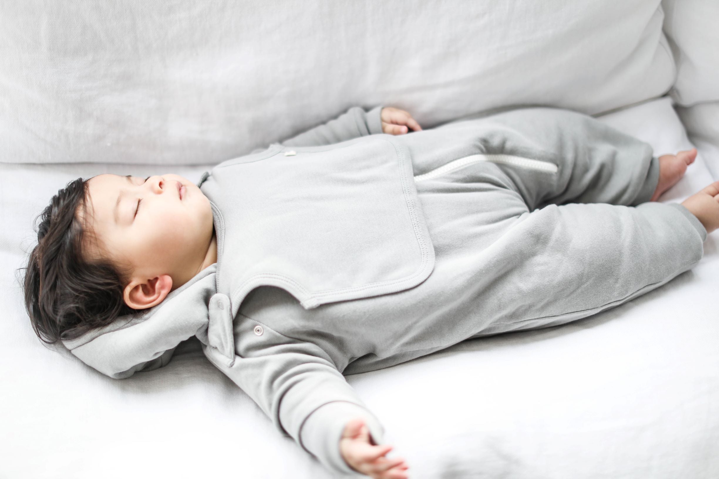 Gray baby jumpsuit with bib by Fuchsia Milo, featuring a soft, cozy design perfect for infant comfort and style.