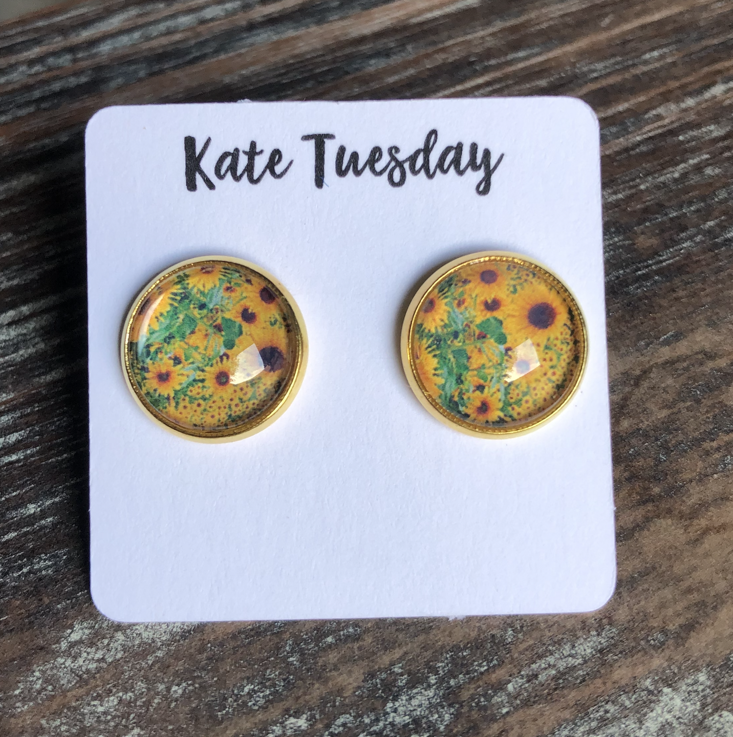 Olive Felix sunflower 12mm round stud earrings made of accessories, featuring bright yellow sunflower design on shiny metal studs.