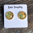 Olive Felix sunflower 12mm round stud earrings made of accessories, featuring bright yellow sunflower design on shiny metal studs.