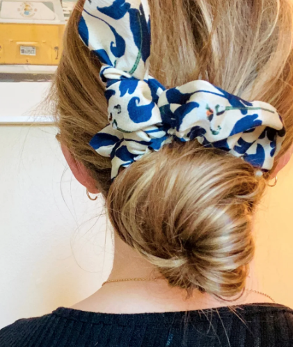 Green Athena chiffon hair scrunchie, soft and lightweight accessory for hair styling, shown in a close-up image.
