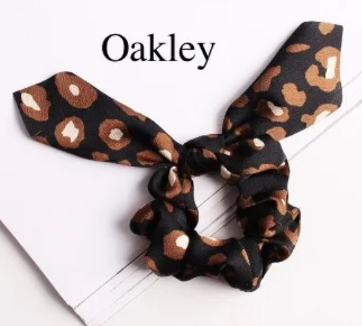 Green Athena chiffon hair scrunchie, soft and lightweight accessory for hair styling, shown in a close-up image.