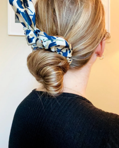 Green Athena chiffon hair scrunchie made of soft, lightweight fabric, shown in a close-up view.