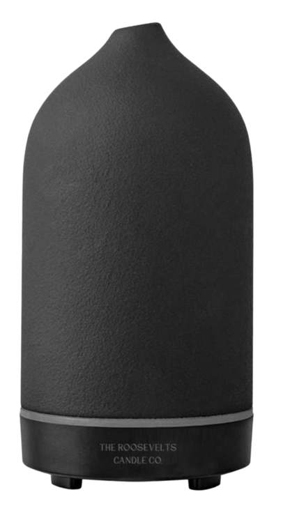 White Dione Stone Aromatic Diffuser with a sleek design, showcasing the diffuser and surrounding essential oils.