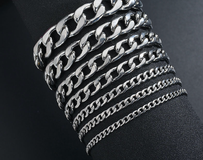 Close-up of a stylish NK chain bracelet by Blush Bella, featuring a sleek silver design on a white background.