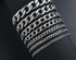 Close-up of a stylish NK chain bracelet by Blush Bella, featuring a sleek silver design on a white background.