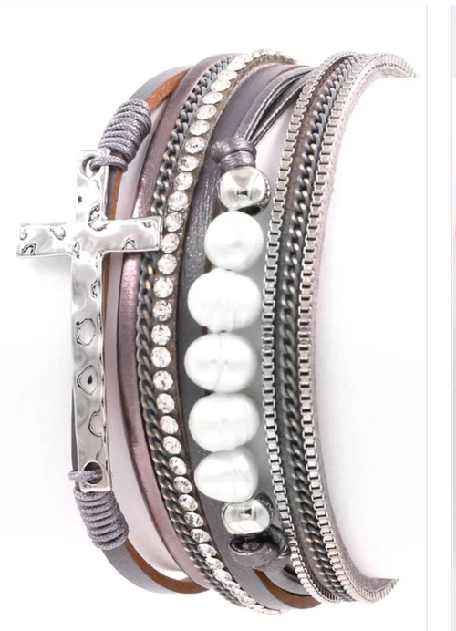 Multi-layer magnetic bracelet with cross and pearl accents by Ochre Ismene, featuring layered design and elegant jewelry style.