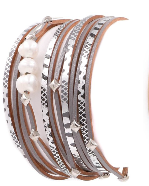 Faux leather pearl layered bracelet by Ochre Ismene featuring multiple strands with pearls and leather accents.