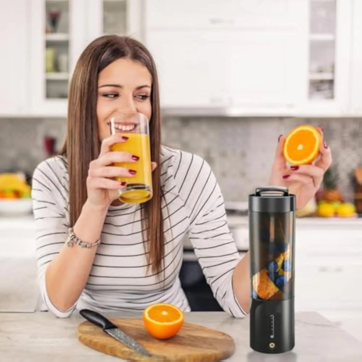 Maroon Asteria portable kitchen blender for fresh juice mixing, wireless charge mini electric device on a countertop.