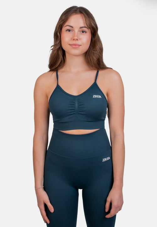 Dark teal Pear Juniper Shape Seamless Sports Bra shown from the front, showcasing its fitted, supportive design for active wear.