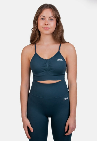 Dark teal Pear Juniper Shape Seamless Sports Bra shown from the front, showcasing its fitted, supportive design for active wear.