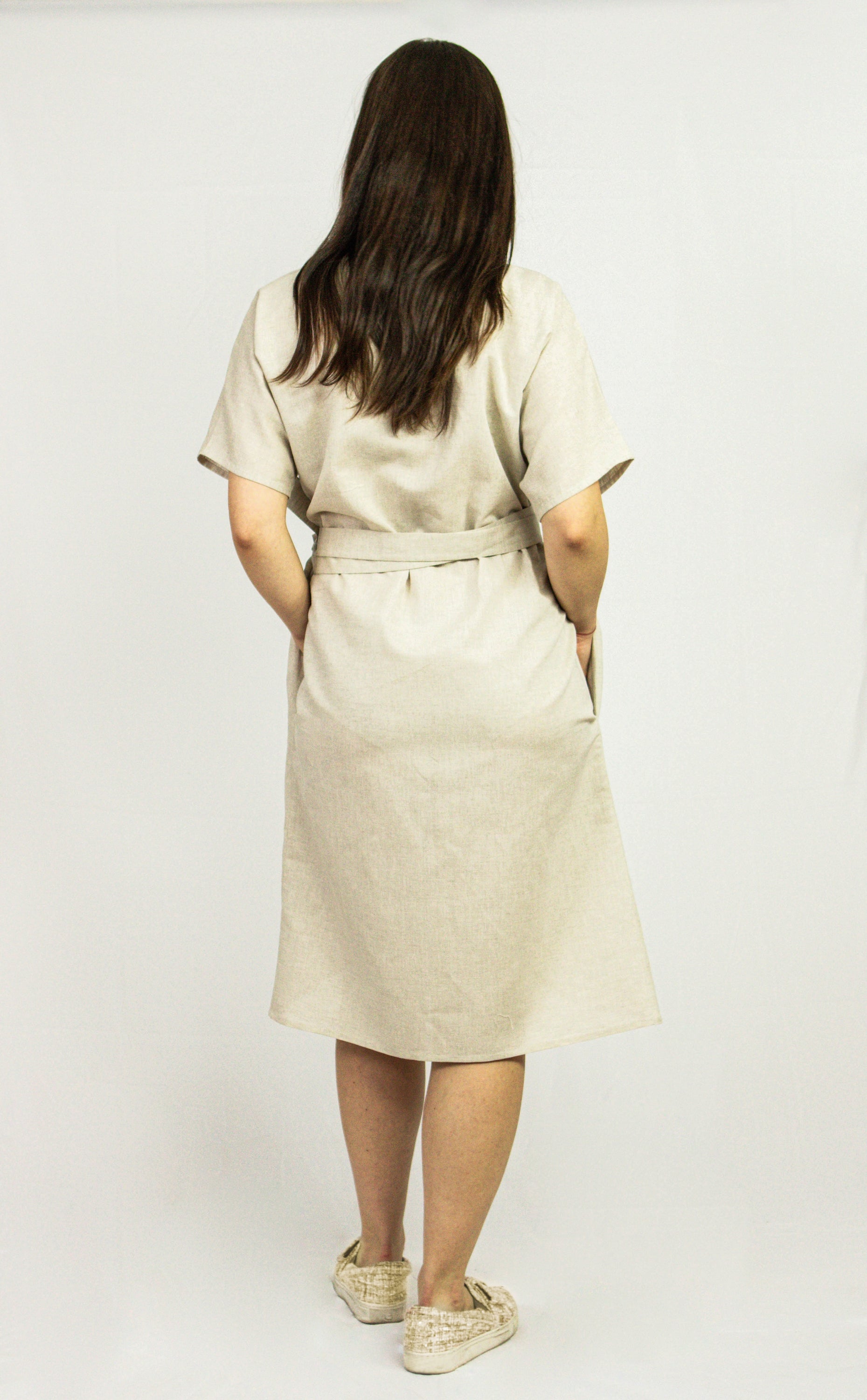 Light beige Natural Light linen wrap dress by Magenta Sugarplum, featuring a fitted waist and flowing fabric.