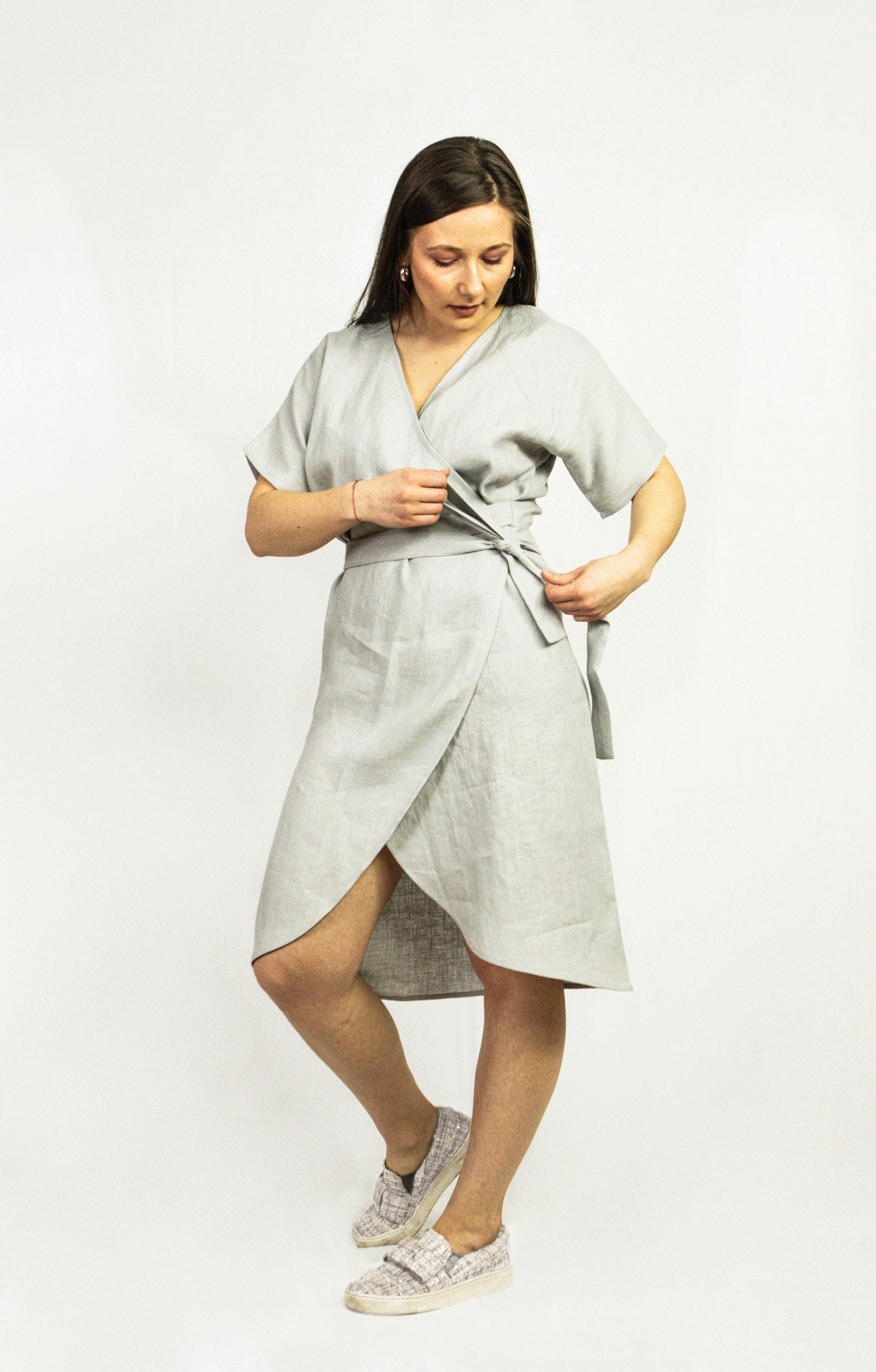 Light grey linen wrap dress by Magenta Sugarplum featuring a relaxed fit and elegant design, shown on a mannequin.