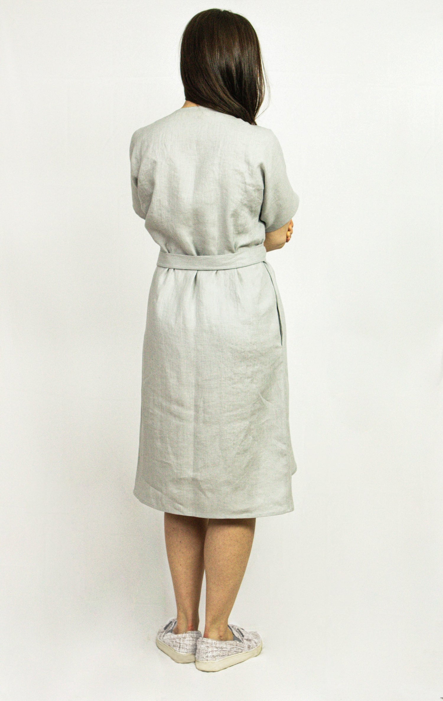 Natural Light linen wrap dress by Magenta Sugarplum, featuring a flowy design and soft fabric, shown on a model.