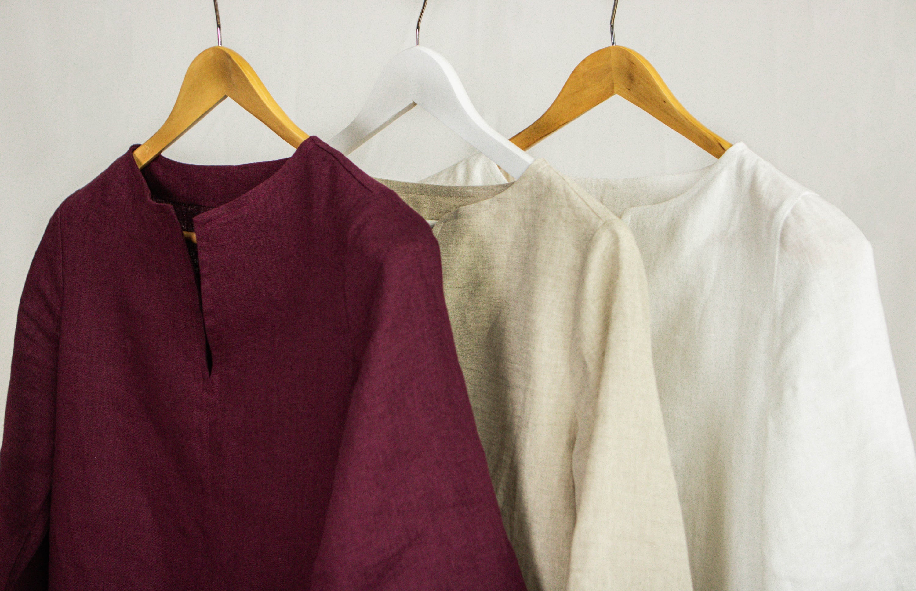 Asphalt grey linen oversize top by Magenta Sugarplum, loose-fit blouse with long sleeves and relaxed style, displayed on a hanger.