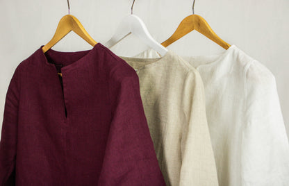 Asphalt grey linen oversize top by Magenta Sugarplum, loose-fit blouse with long sleeves and relaxed style, displayed on a hanger.