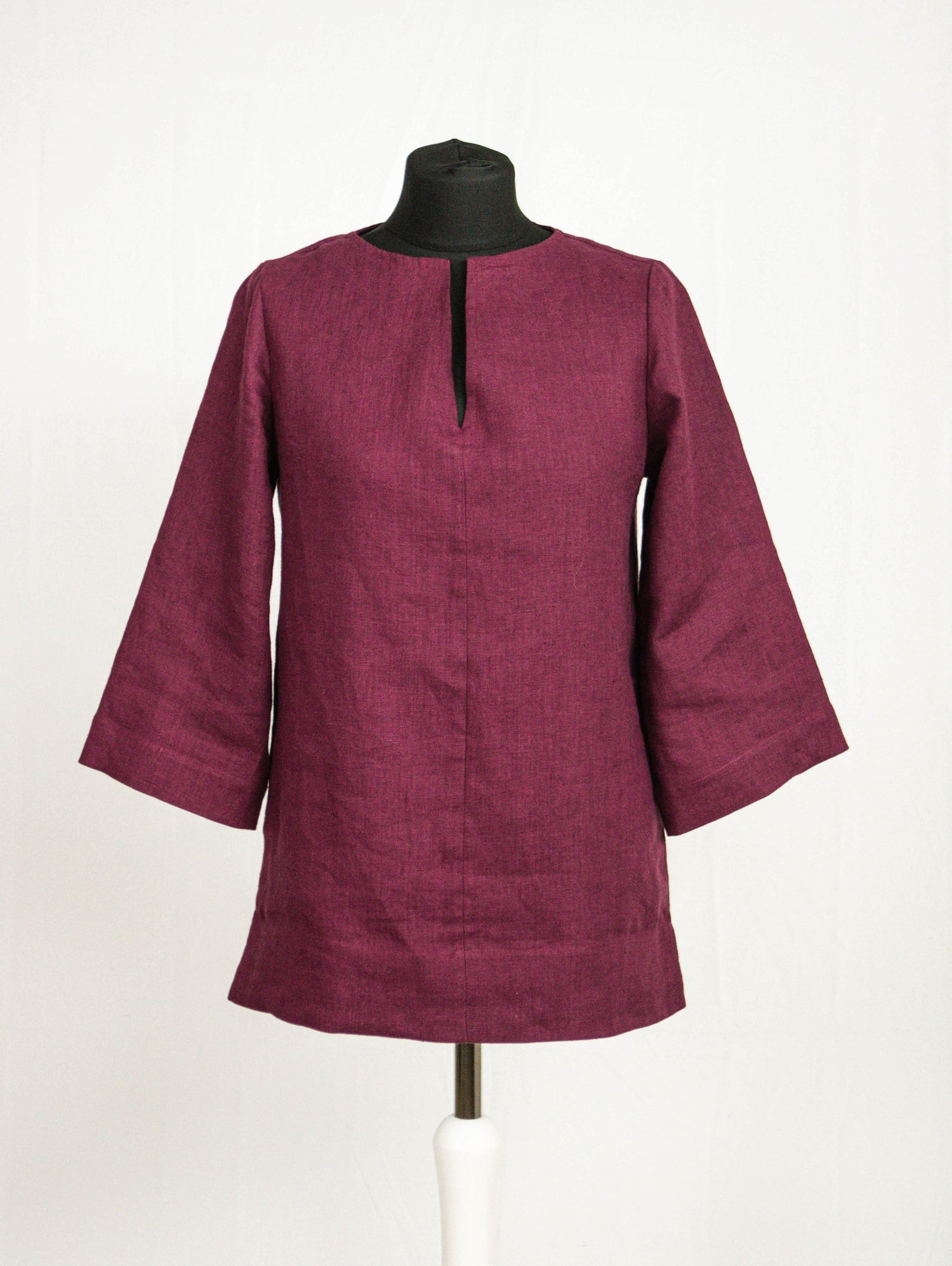 Dark plum linen oversize top by Magenta Sugarplum, featuring a relaxed fit and long sleeves, shown on a model.