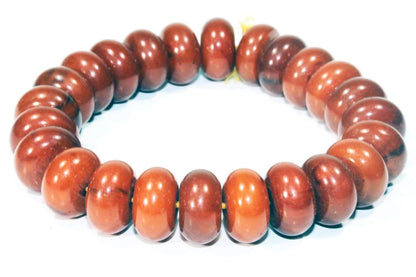 Earthy brown tribal bracelet by Silver Hestia, featuring intricate bead and metal designs, displayed on a neutral background.