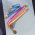 Yellow Athena skinny ombre bracelet in blue, pink, and orange with a sleek, colorful design on a white background.