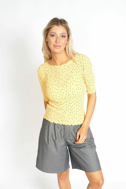 Yellow polka dot top with ruffled frill details from Azure Thanatos, perfect for casual or chic outfits.