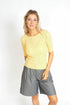 Yellow polka dot top with ruffled frill details from Azure Thanatos, perfect for casual or chic outfits.