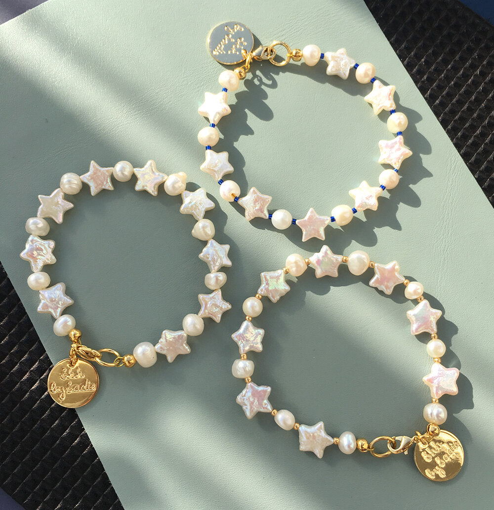 Yellow Athena Pearl Stars bracelet featuring pearl and star-shaped charms on a delicate bracelet chain.