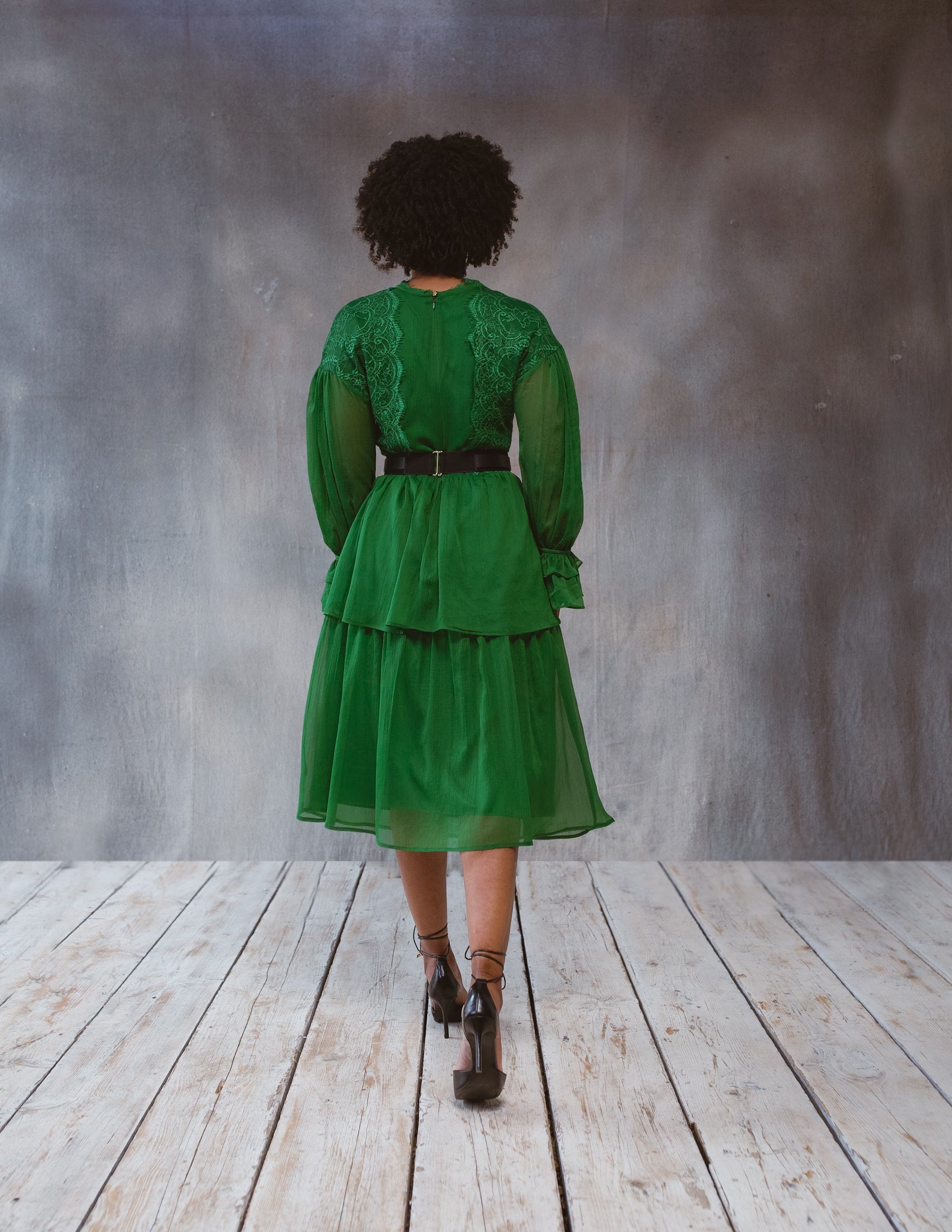 Green lace dress from BethAle London by Erin Ophion, shown in a still life image highlighting intricate lace details and elegant style.