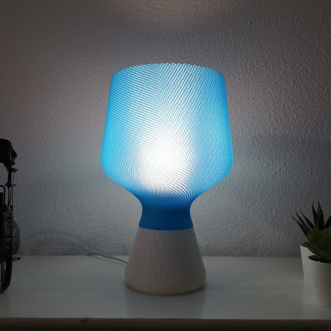 Azure Pontus Summer Glow table lamp in blue with a modern, sleek design suitable for contemporary lighting decor.