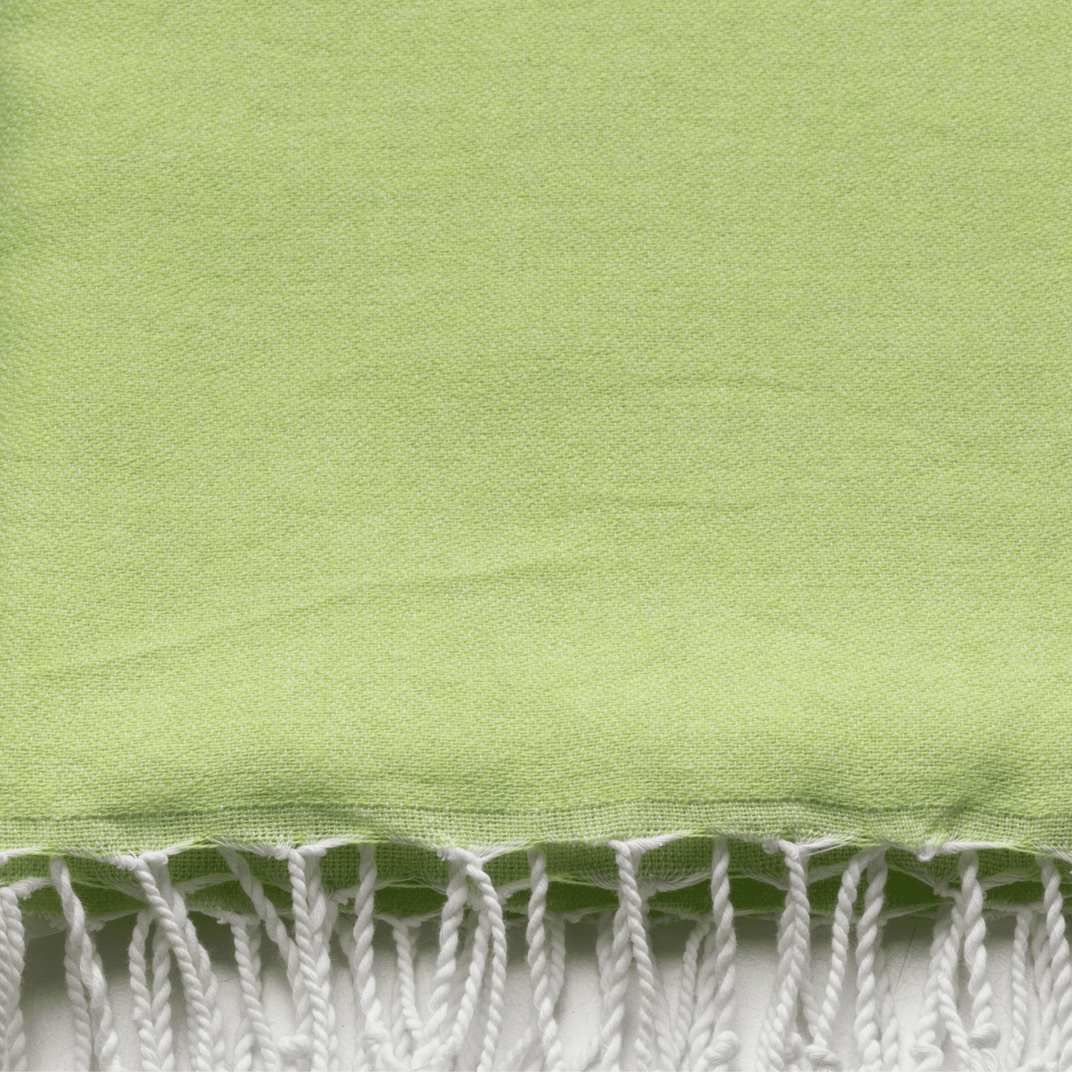 Neon mint and lime 2-in-1 hammam towel bag made of recycled cotton by Copper Amymone, showcasing vibrant colors and compact design.