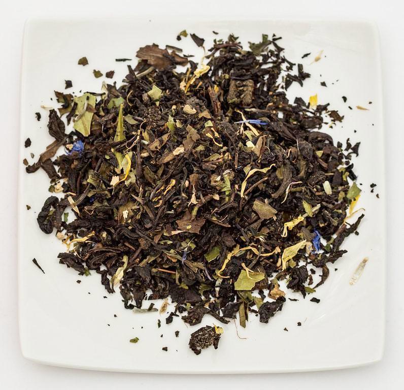 Two loose tea leaves infused with white wine and peach flavor, displayed in a glass jar for Violet Strawberry&