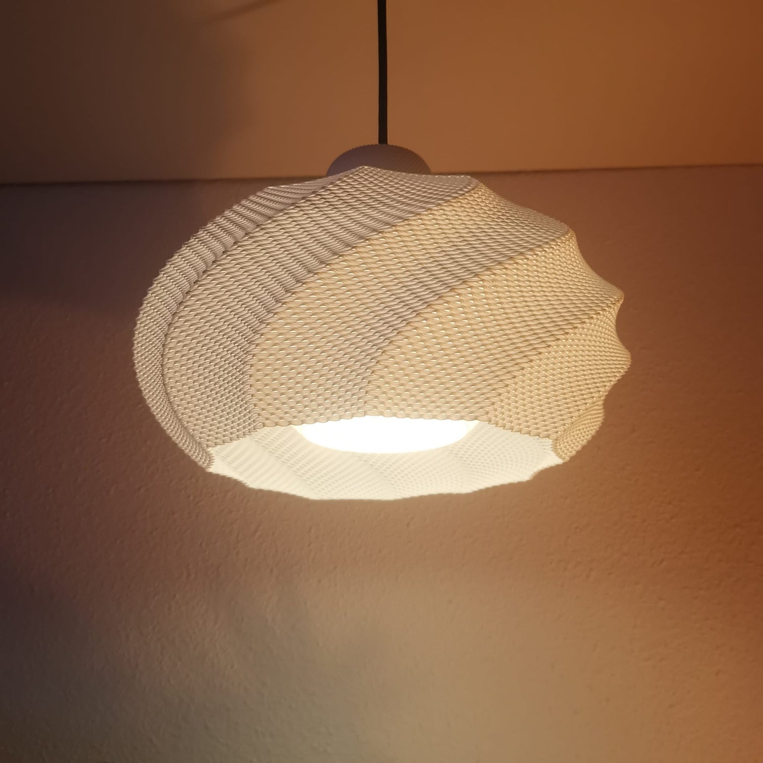 Azure Pontus Twist Glow pendant lamp with a twisting, modern design, perfect for stylish lighting in living spaces.