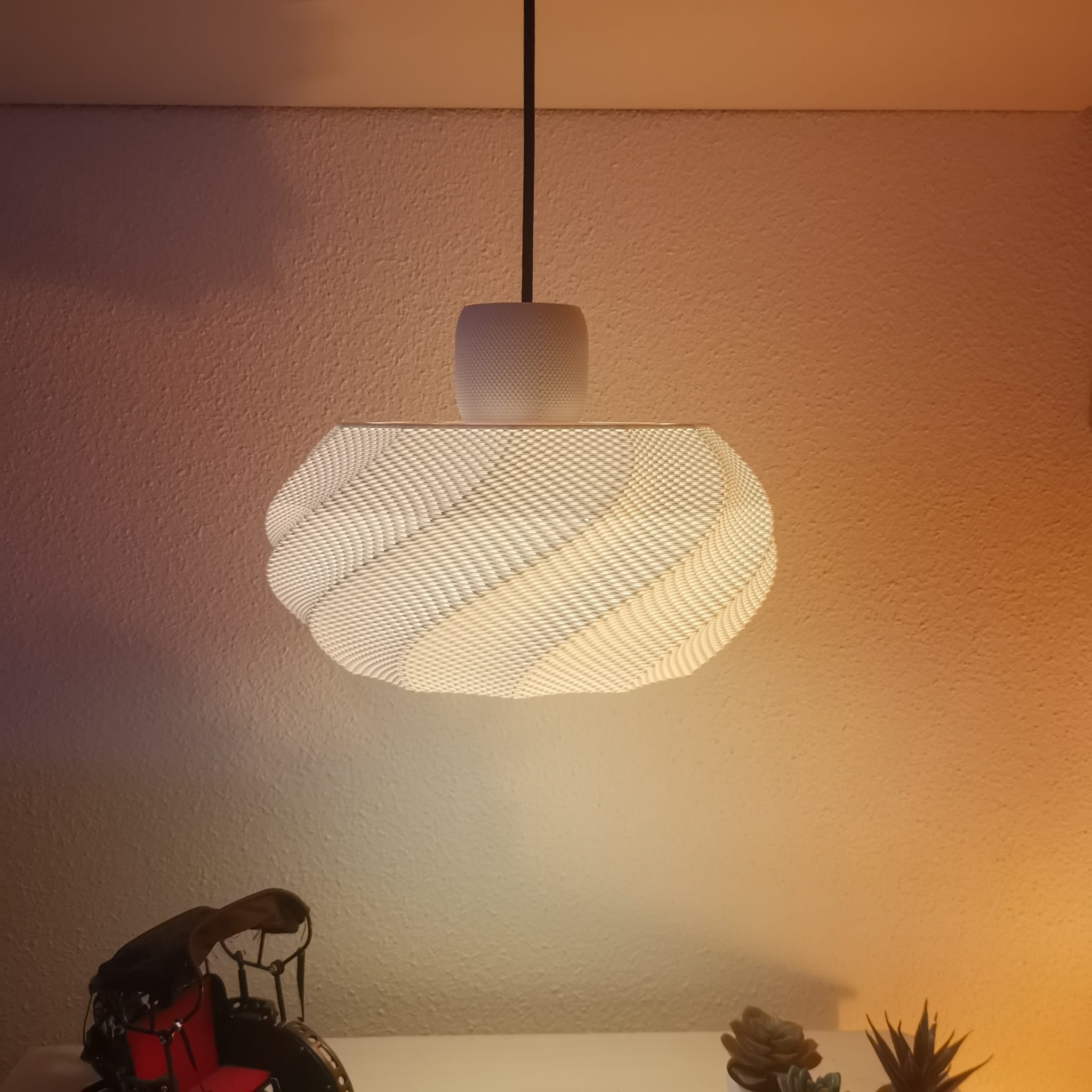 Azure Pontus Twist Glow Pendant Lamp hanging with a modern design, featuring a twisting glass shade for stylish lighting.