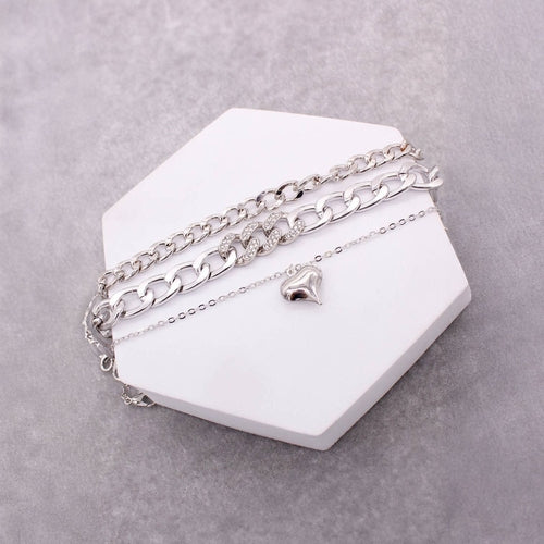 Set of three assorted heart pendant chain bracelets by Lavender Tartarus, featuring delicate jewelry with charming heart designs.