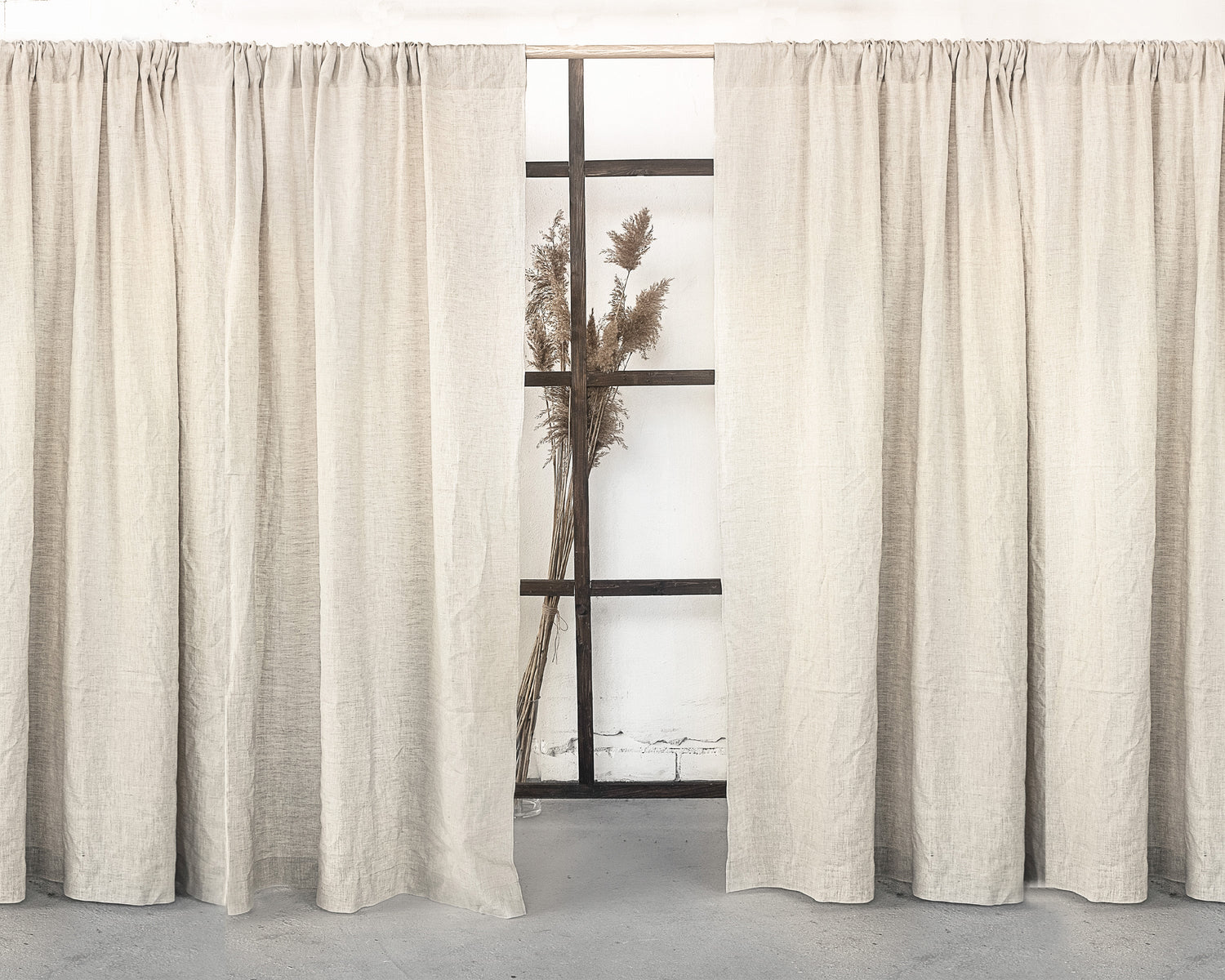 Grey linen curtain with rod pocket from Magenta Sugarplum, showcasing a soft, textured fabric hanging on a curtain rod.
