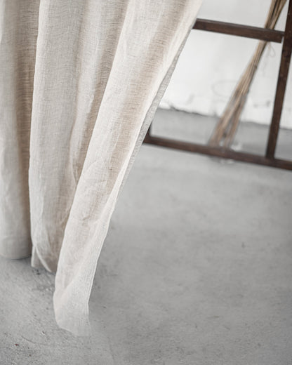 Grey linen curtain with rod pocket from Magenta Sugarplum, hanging on a curtain rod in a home decor setting.