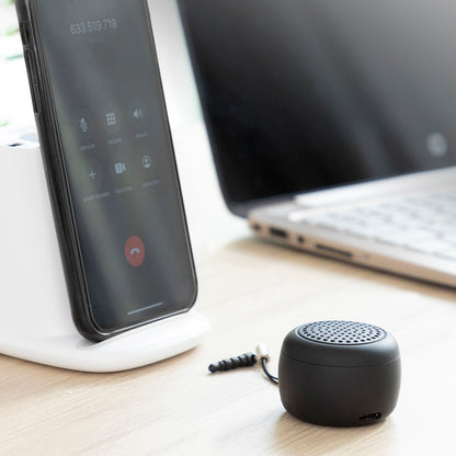 Rechargeable portable wireless mini speaker by Miund InnovaGoods, compact and black with control buttons and a built-in rechargeable battery.