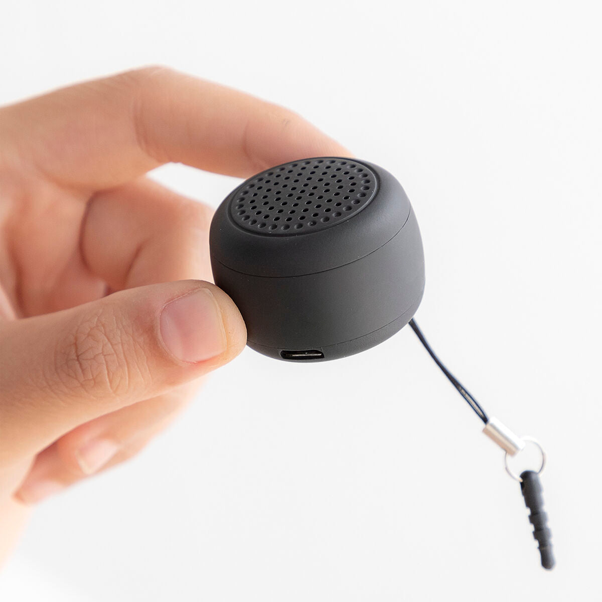 Rechargeable portable wireless mini speaker by Miund InnovaGoods, shown in black with control buttons and compact design.