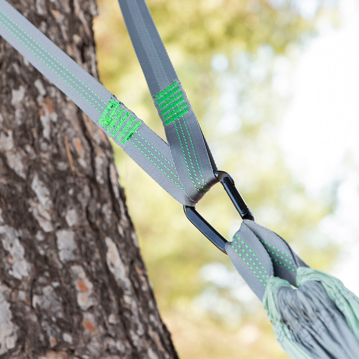 Double camping hammock by Bigbuy for outdoor relaxation, shown hanging between trees with lush nature in the background.