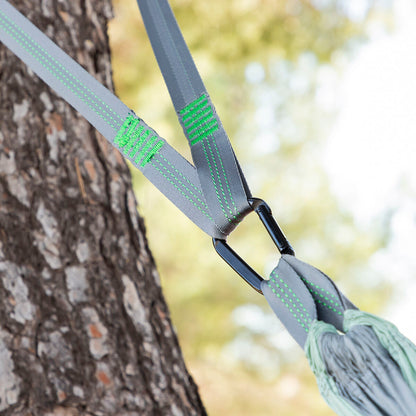 Double camping hammock by Bigbuy for outdoor relaxation, shown hanging between trees with lush nature in the background.