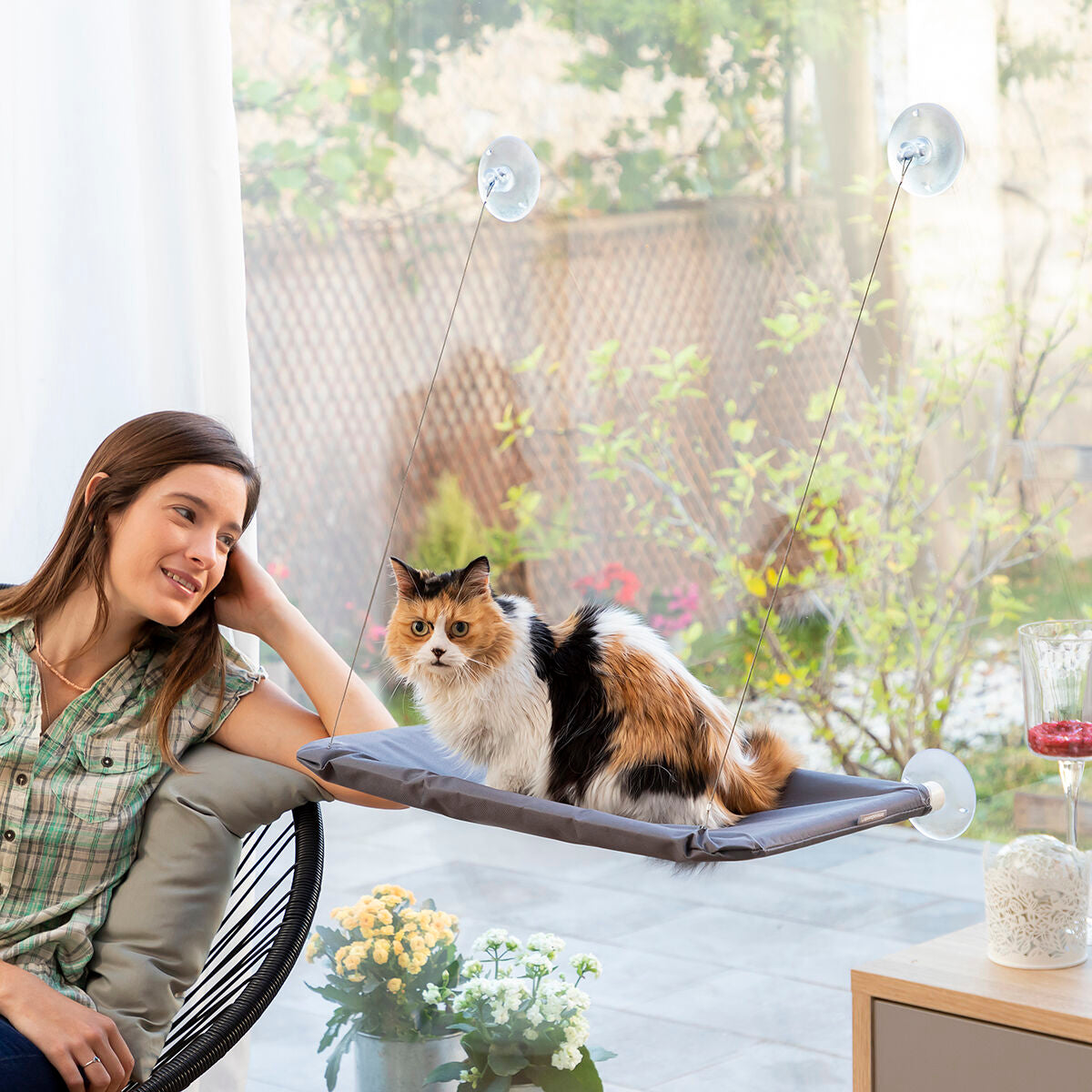 Hanging cat hammock by Bigbuy InnovaGoods for pets, showing a cozy fabric hammock with attached straps and a cat lounging inside.