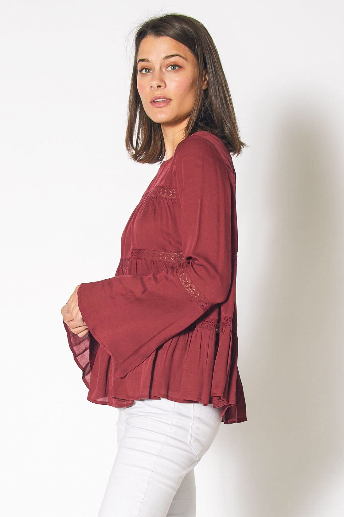 Red Cordovan bell sleeve tiered blouse from Lemon Hera, featuring flowing fabric and stylish bell sleeves.